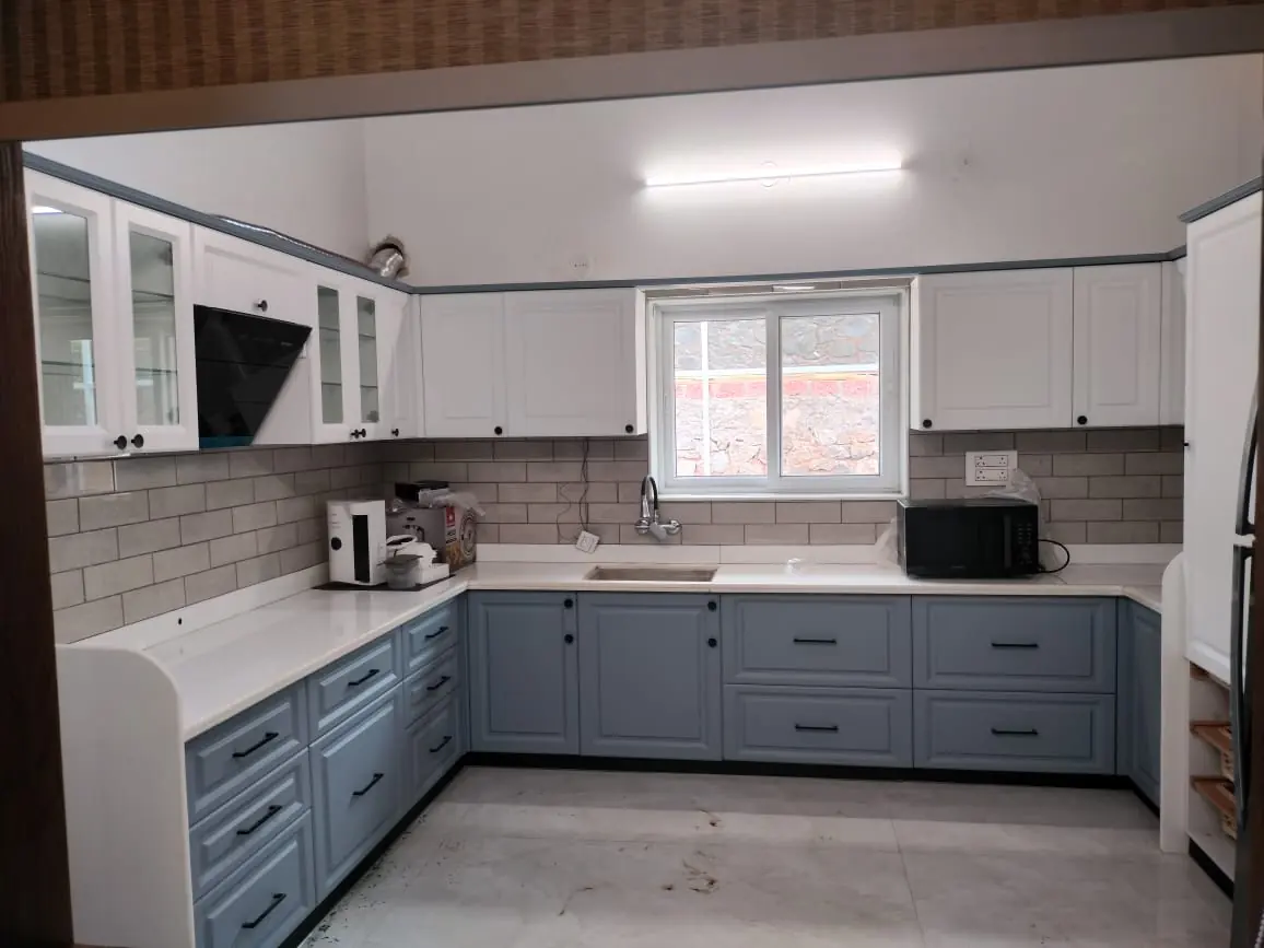 White and blue-grey U-shaped modular kitchen installed by Bella Kitchens in Pune